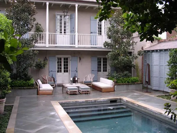 Custom home exterior with pool and lounge seating