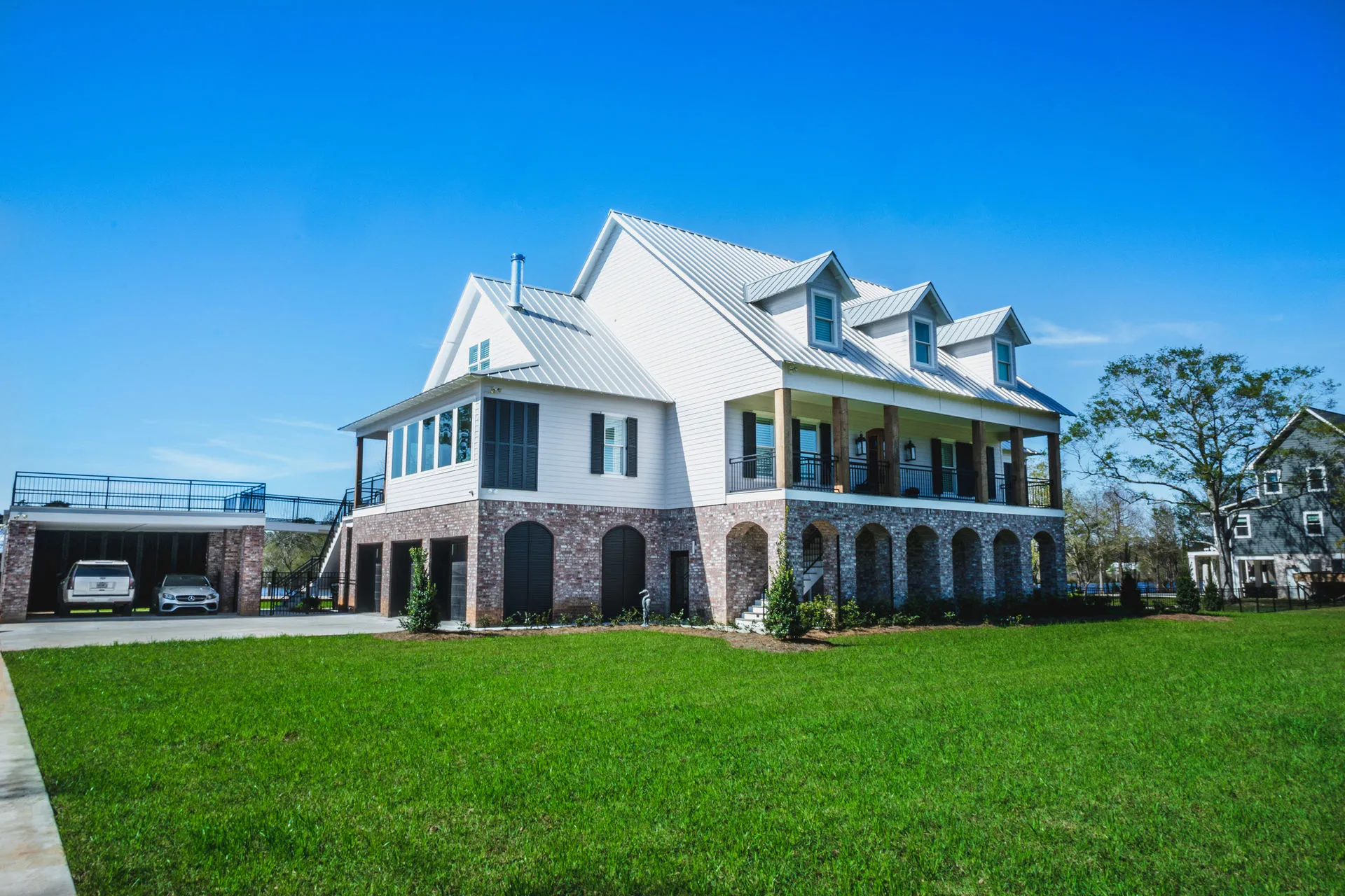 Custom-built two-story home with white siding and wraparound porch in St. Tammany Parish, Louisiana
