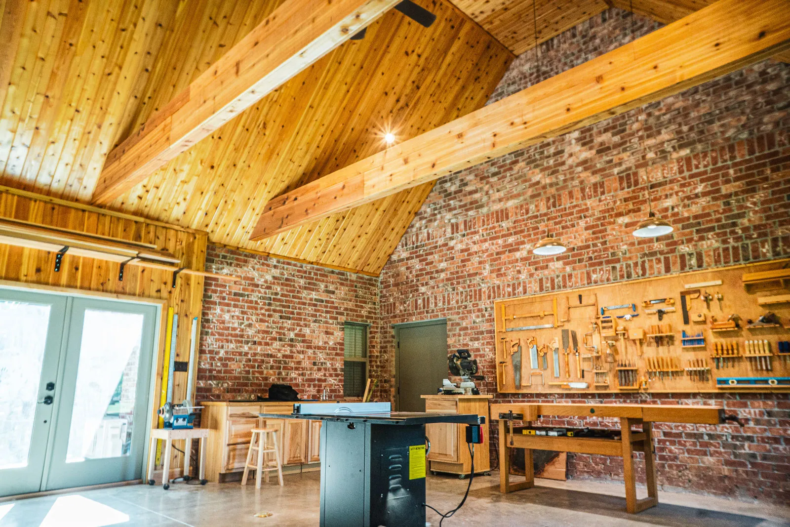 Custom kitchen with wood-beamed ceiling and brick detailing