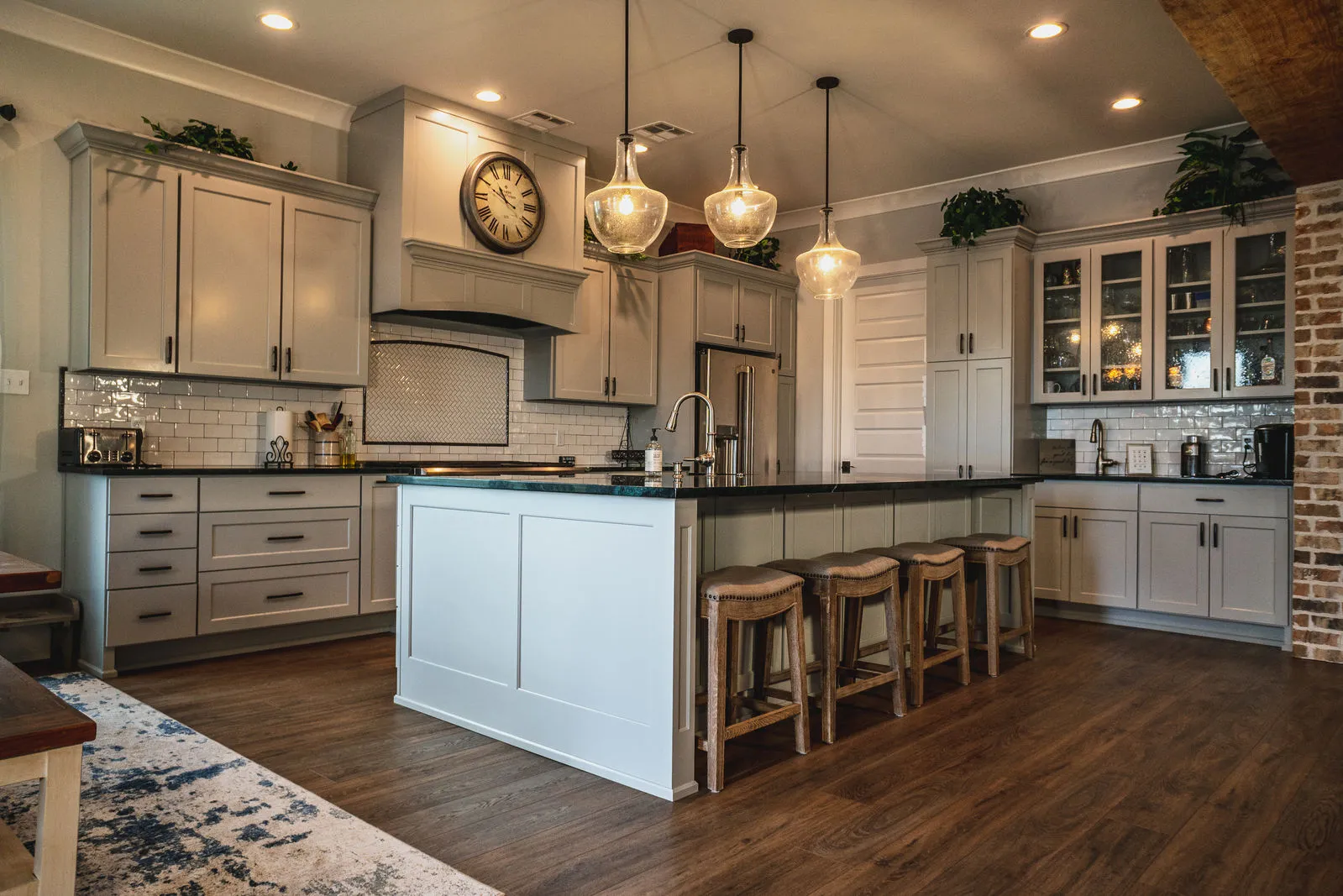 Bright custom kitchen with white cabinetry and island seating